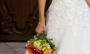 A brides holding a bouquet wearing a bracelet from Anna Bellagio.