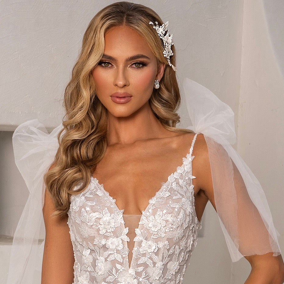 Kennedy Floral Pearl Earrings designed by Anna Bellagio. Model is wearing a Kitty Chen Bridal Gown.