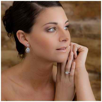 Cianna Cubic Zirconia and Crystal Earrings from Anna Bellagio model wearing them with her hands crossed.